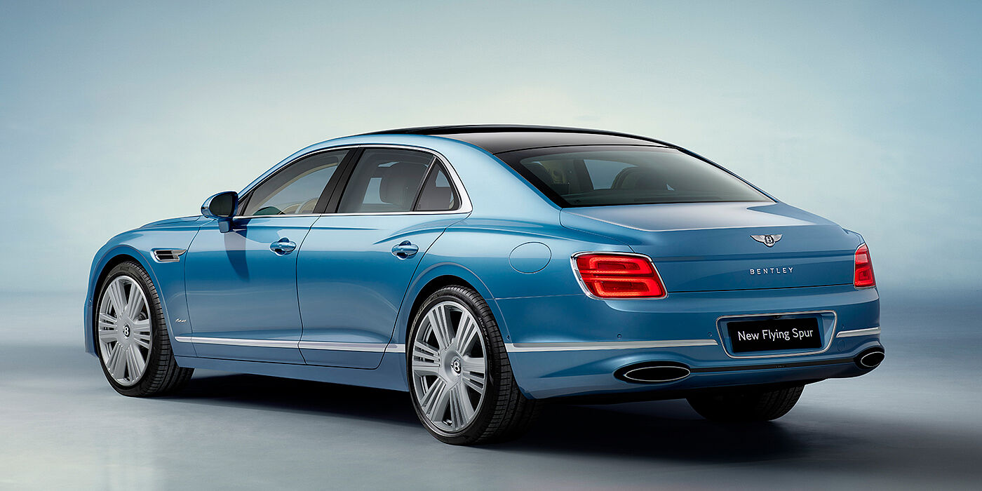 Gohm Sportwagen GmbH | Bentley Stuttgart New Bentley Flying Spur Azure sedan rear view in Light windsor blue by Mulliner paint with 22 inch Azure wheels and chrome exterior details