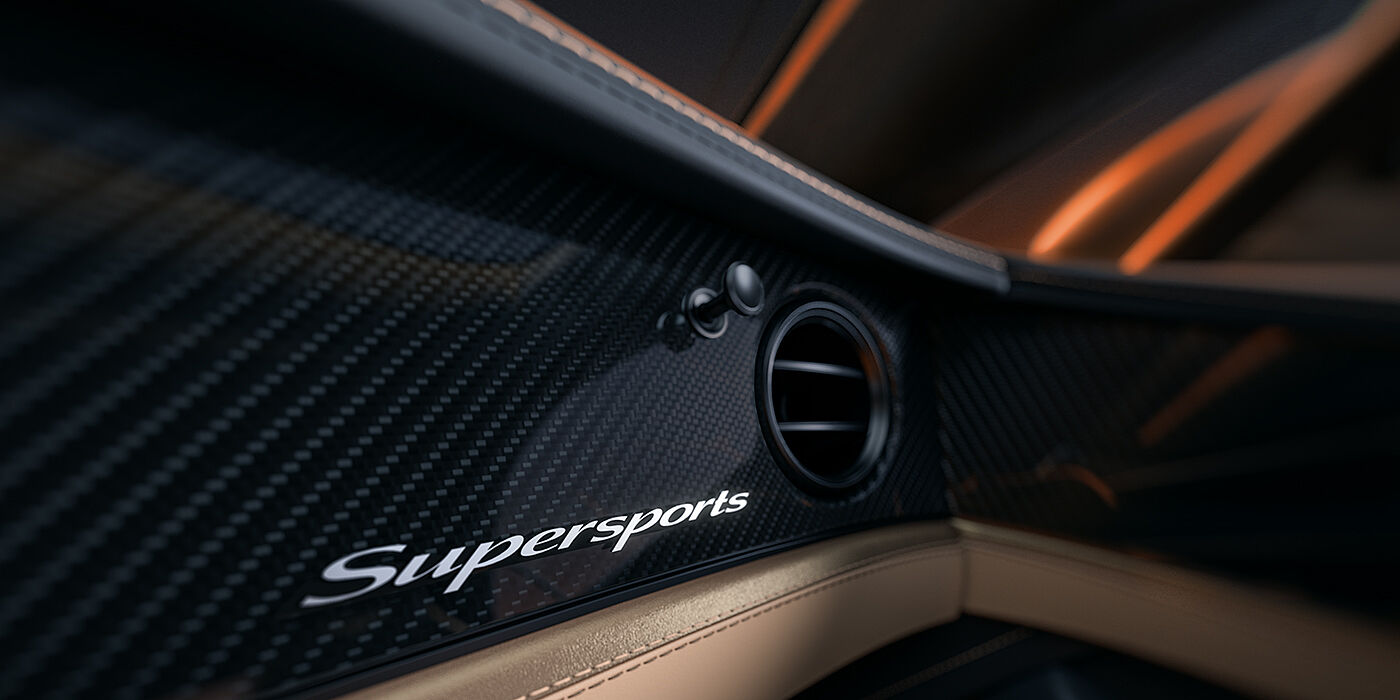 Gohm Sportwagen GmbH | Bentley Stuttgart Bentley Supersports front interior high gloss black carbon fibre veneer detail with Supersports badge