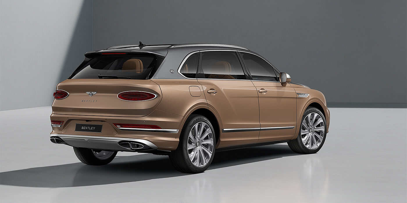 Gohm Sportwagen GmbH | Bentley Stuttgart Bentley Bentayga EWB Mulliner SUV in Magnetic and Rose Gold paint and 22" Mulliner wheels rear ¾