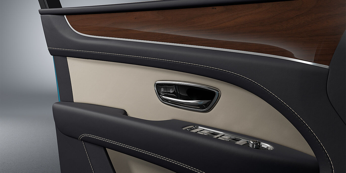 Gohm Sportwagen GmbH | Bentley Stuttgart Bentley Bentayga EWB SUV door interior detail in Portland and Imperial Blue hides with Crown Cut Walnut veneer