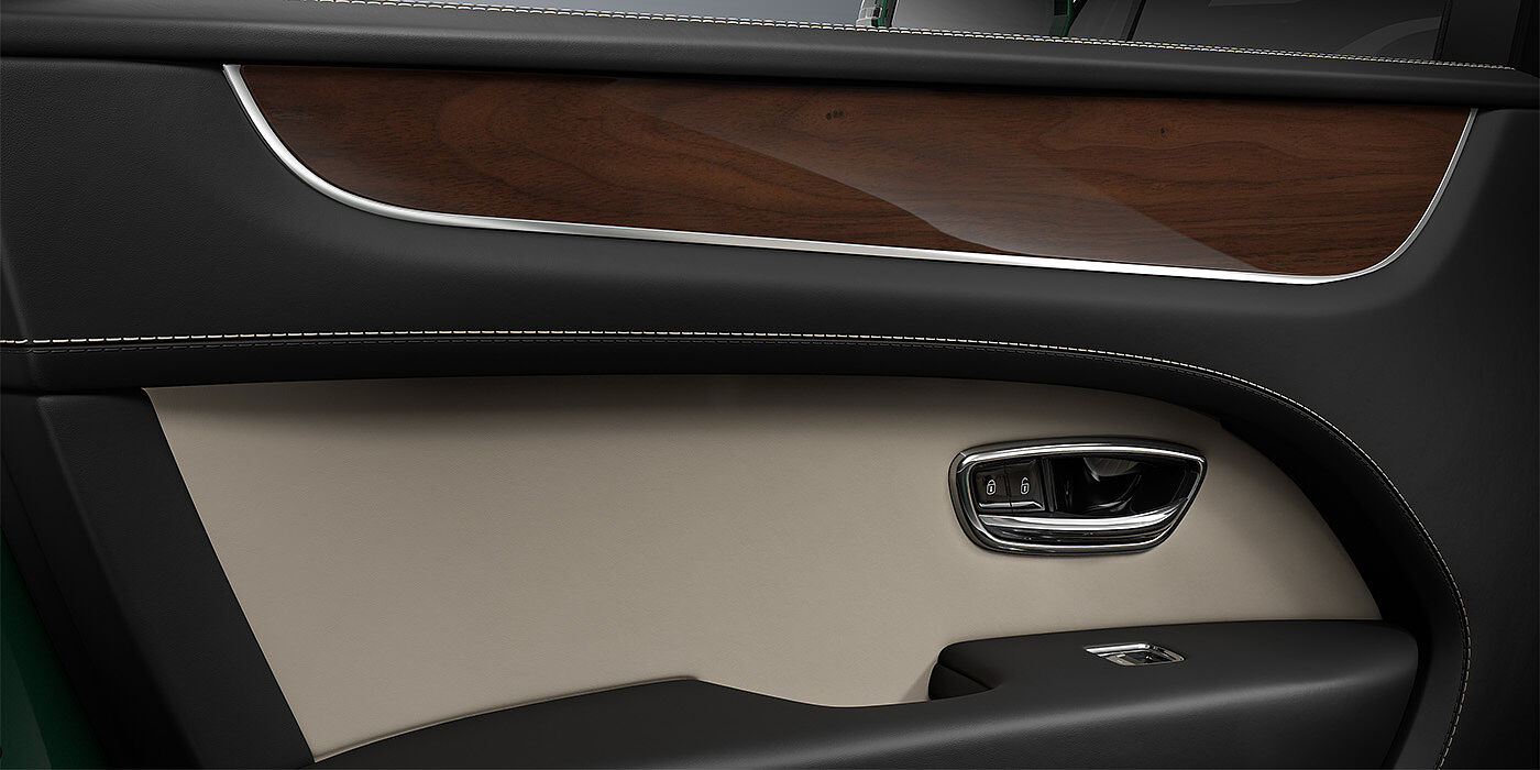 Gohm Sportwagen GmbH | Bentley Stuttgart Bentley Bentayga SUV door interior detail in Portland and Beluga black hides with Crown Cut Walnut veneer