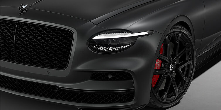 Gohm Sportwagen GmbH | Bentley Stuttgart New Bentley Flying Spur S sedan head lamp against Anthracite Satin paint with  22" Sports wheel