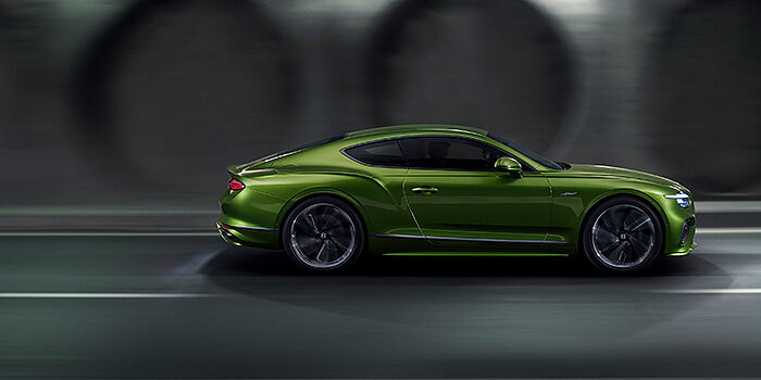  Gohm Sportwagen GmbH | Bentley Stuttgart Bentley Continental GT coupe in Tourmaline Green paint driving in profile on a dark road