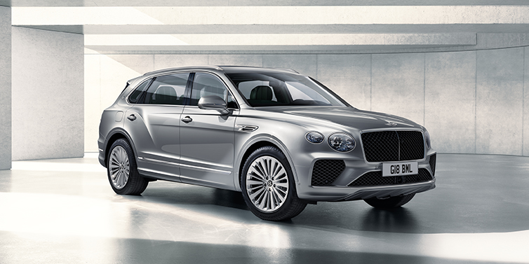 Gohm Sportwagen GmbH | Bentley Stuttgart Bentley Bentayga Extended Wheelbase SUV front three quarter in Moonbeam paint with a grey background