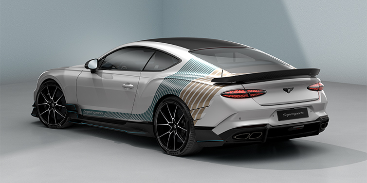 Gohm Sportwagen GmbH | Bentley Stuttgart Bentley Supersports rear three quarter in "Snowstorm" Design theme with Snow Quartz paint and Topaz blue and Camel brown paint stripes across the rear haunch.