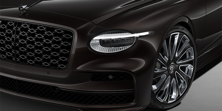 Gohm Sportwagen GmbH | Bentley Stuttgart New Bentley Flying Spur Mulliner sedan head lamp against Havana brown paint with  22" Mulliner Black Painted & Polished wheel
