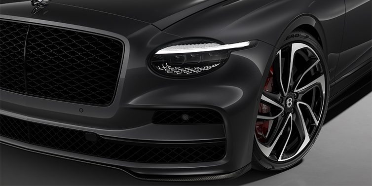 Gohm Sportwagen GmbH | Bentley Stuttgart New Bentley Flying Spur Speed sedan head lamp against Magnetic paint with  22" Swept spoke Black & Machined wheel